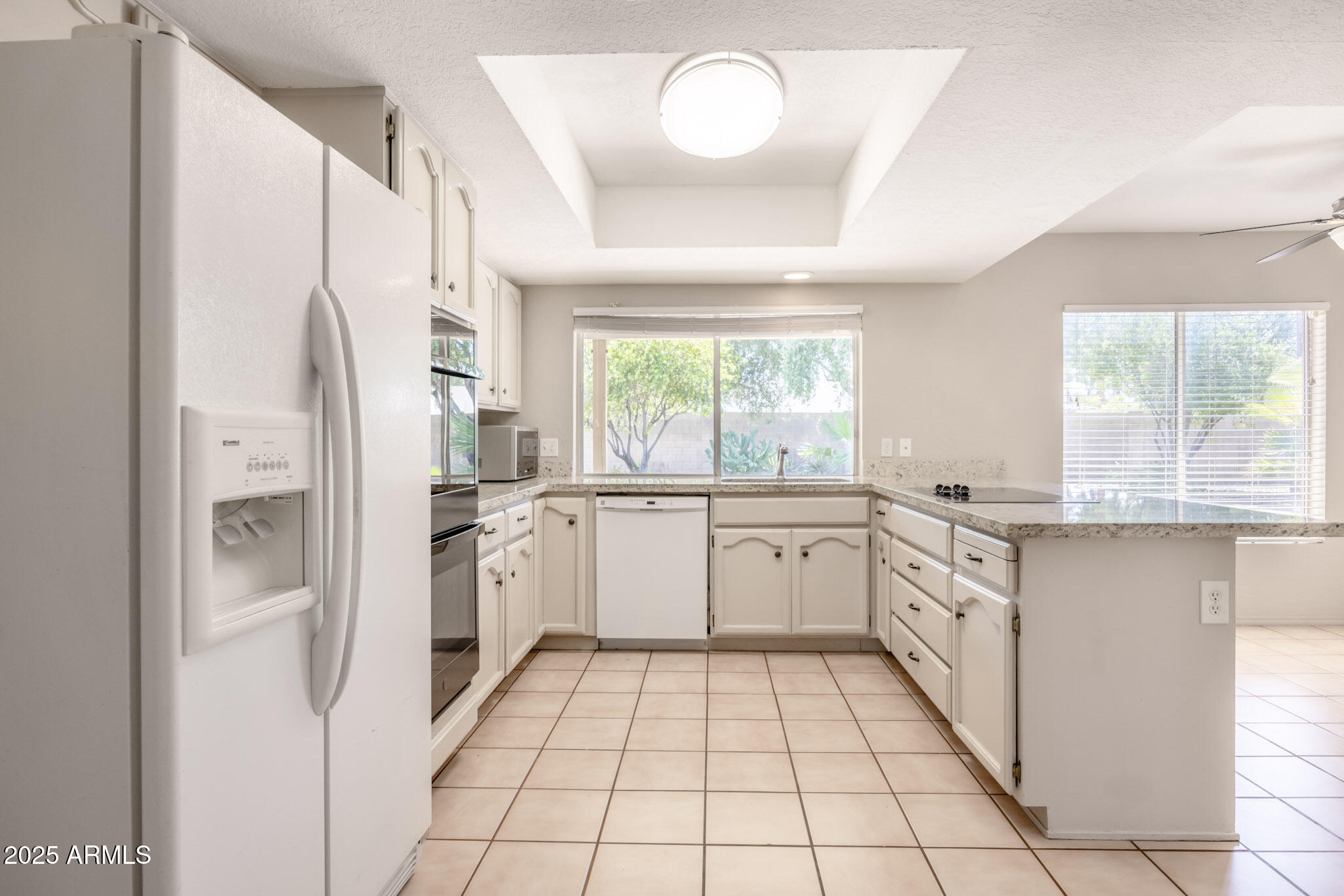 5701 East Sandy Lane Scottsdale, AZ 85254 - Photo 16 of 48 a kitchen with granite countertop appliances a sink and a refrigerator
