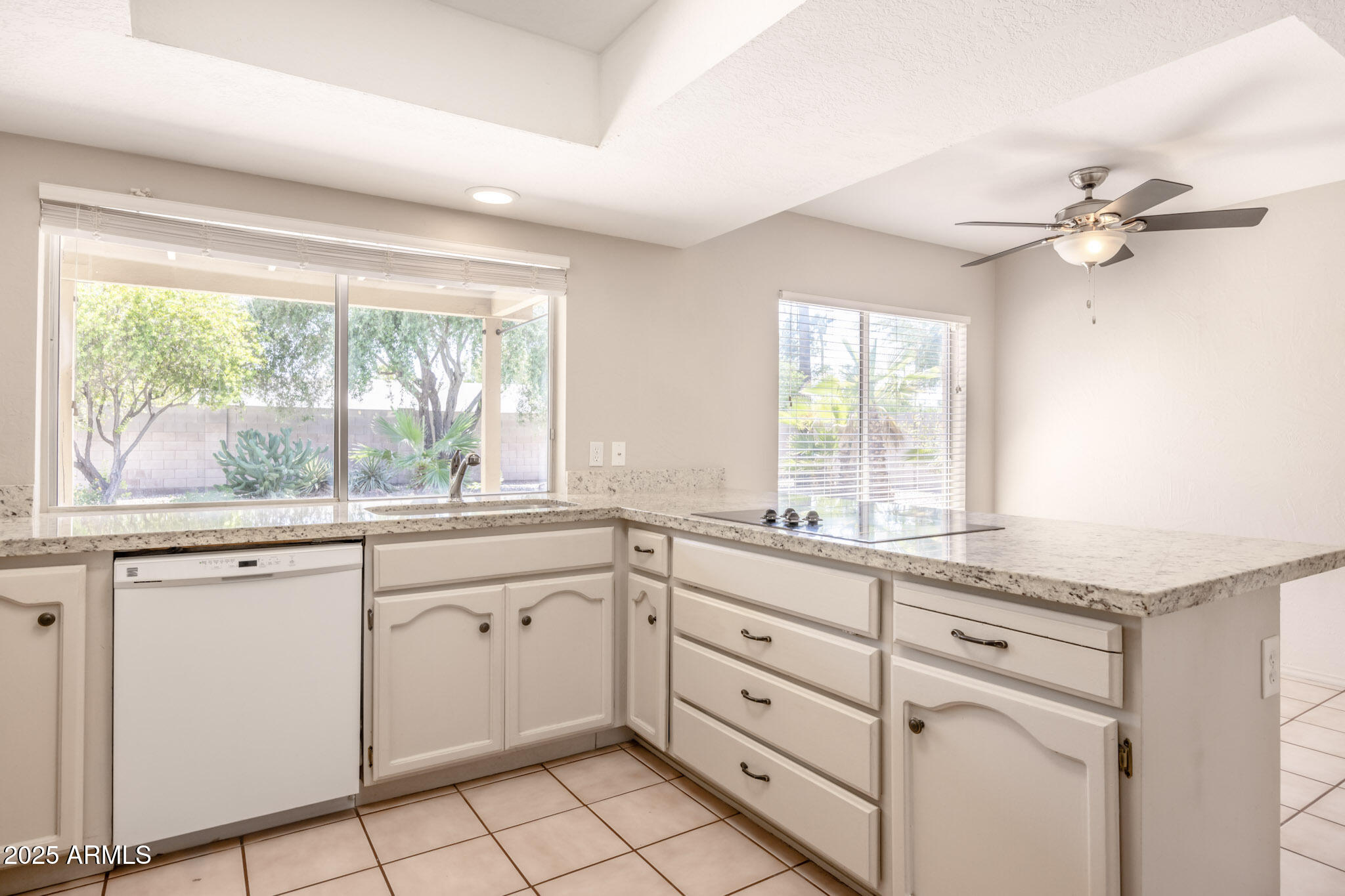 5701 East Sandy Lane Scottsdale, AZ 85254 - Photo 18 of 48 a kitchen with white cabinets and window