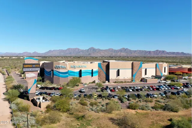 a view of a sign board with parking area