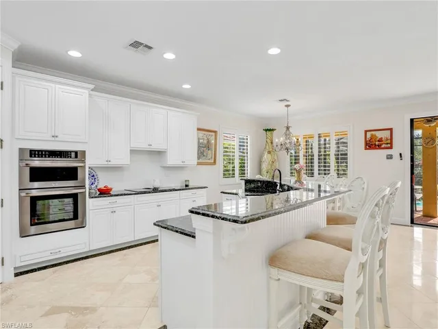 a kitchen with stainless steel appliances granite countertop a stove and a sink
