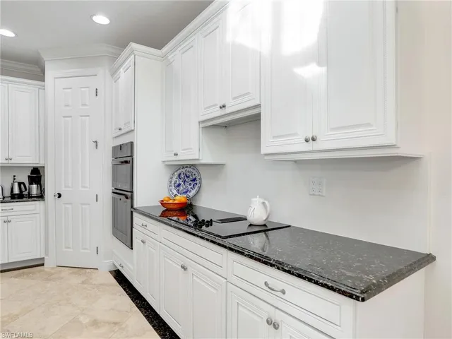 a kitchen with stainless steel appliances granite countertop a sink and cabinets