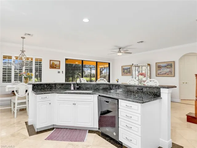a kitchen with granite countertop a sink and cabinets