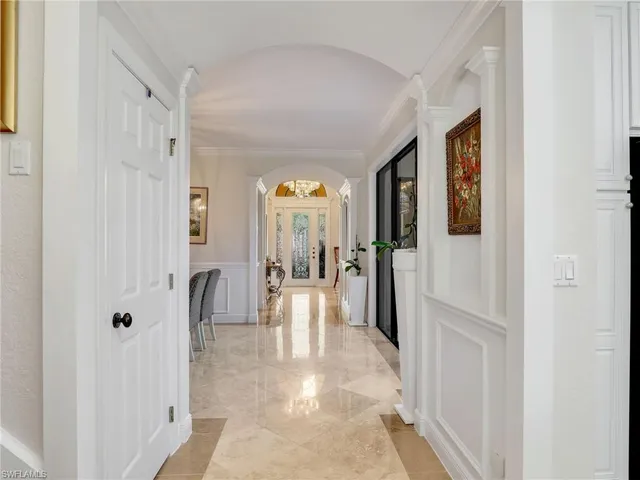 a view of a hallway with furniture and a livingroom view