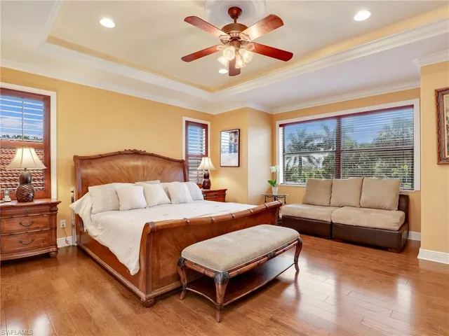 a bedroom with a bed couch and window