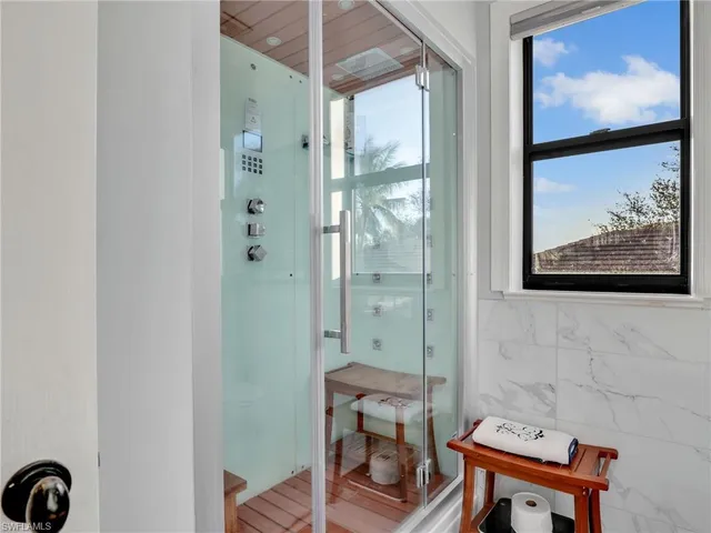 a bathroom with a shower and a mirror