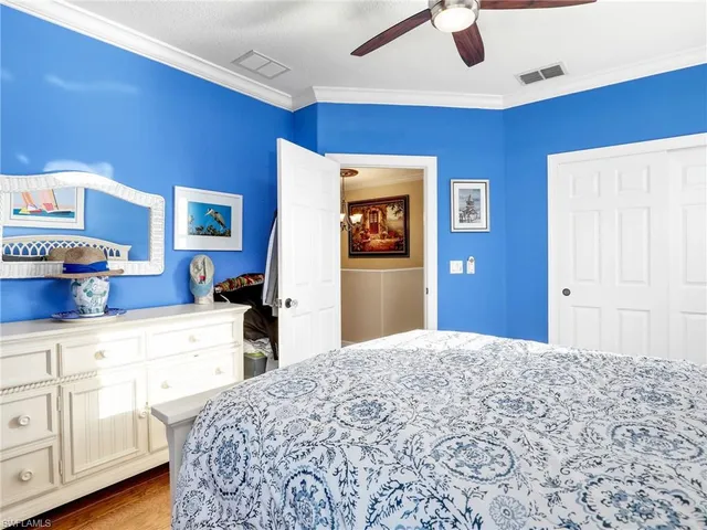 a bedroom with bed and cabinets