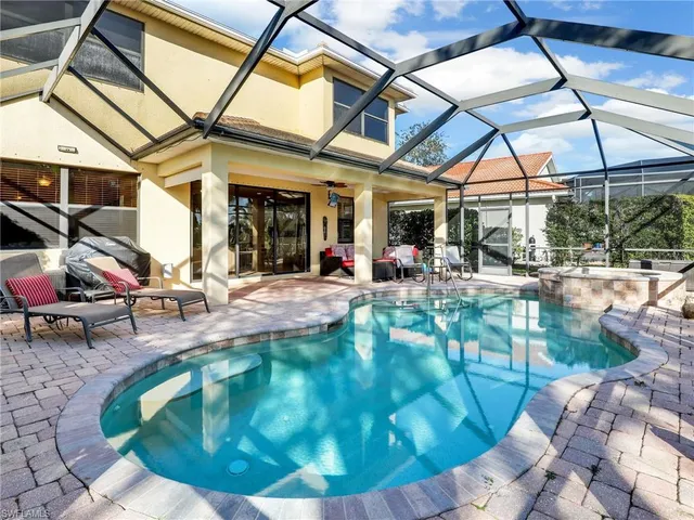 a view of a backyard with a patio and fire pit