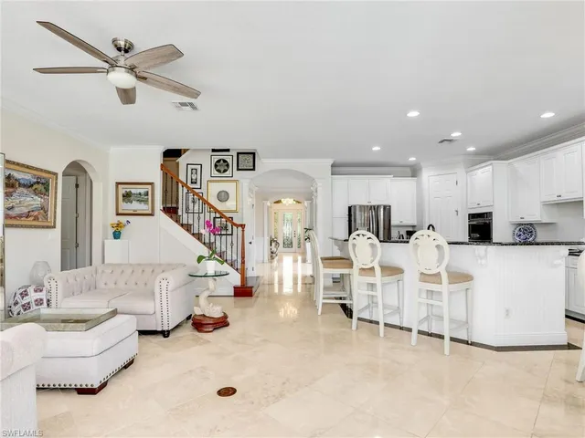 a living room with furniture and a ceiling fan