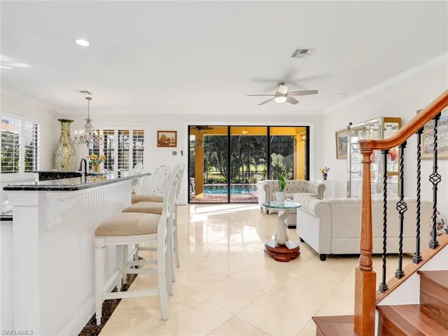 a view of a livingroom with furniture and floor to ceiling window