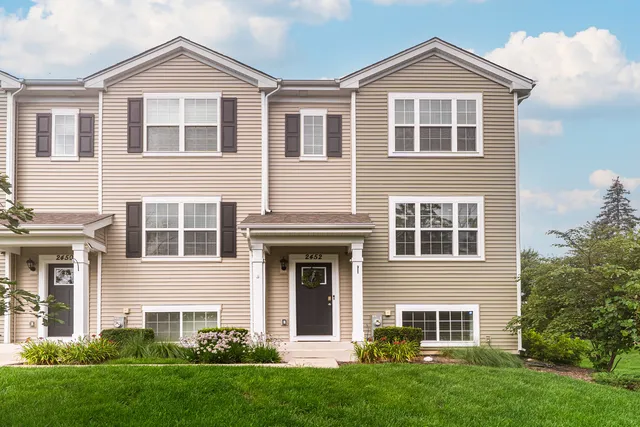 a front view of a house with a yard