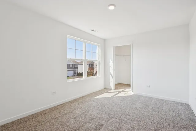 a bedroom with two beds and a window