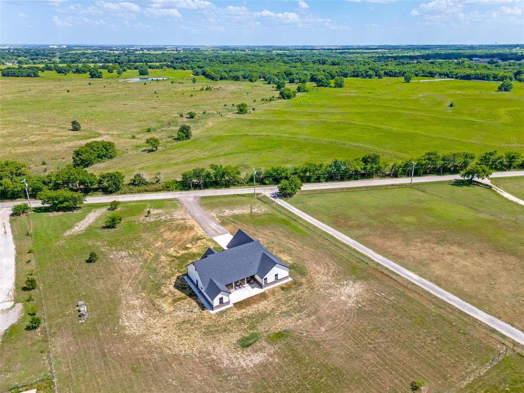 3150 Crisp Road Ennis, TX 75119 - Photo 26 of 30 Contemporary ranch-style residence featuring a dark shingle roof and white exterior siding