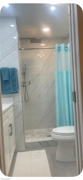200 Turtle Lake Court, Unit 309 Naples, FL 34105 - Photo 11 of 17 a bathroom with a shower and a toilet