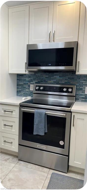 200 Turtle Lake Court, Unit 309 Naples, FL 34105 - Photo 4 of 17 a stove top oven sitting inside of a kitchen