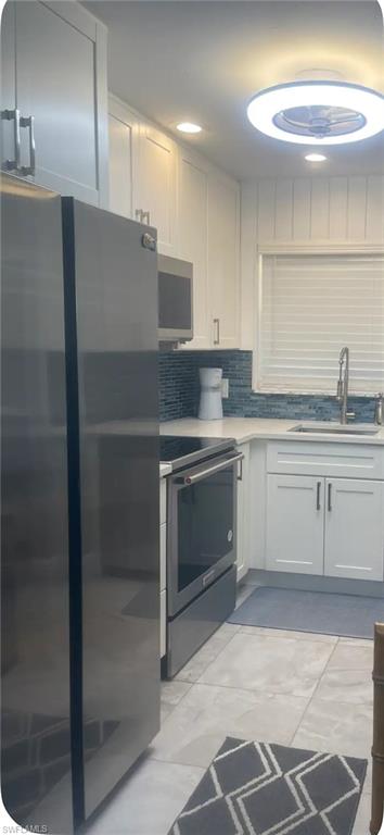 200 Turtle Lake Court, Unit 309 Naples, FL 34105 - Photo 5 of 17 a kitchen with a sink stainless steel appliances and cabinets