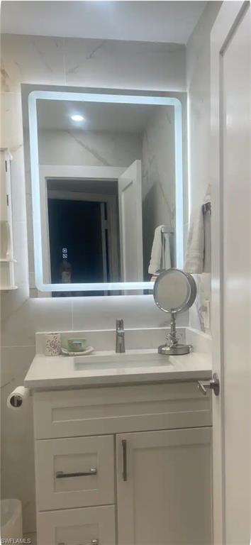 200 Turtle Lake Court, Unit 309 Naples, FL 34105 - Photo 6 of 17 a bathroom with a sink and a mirror