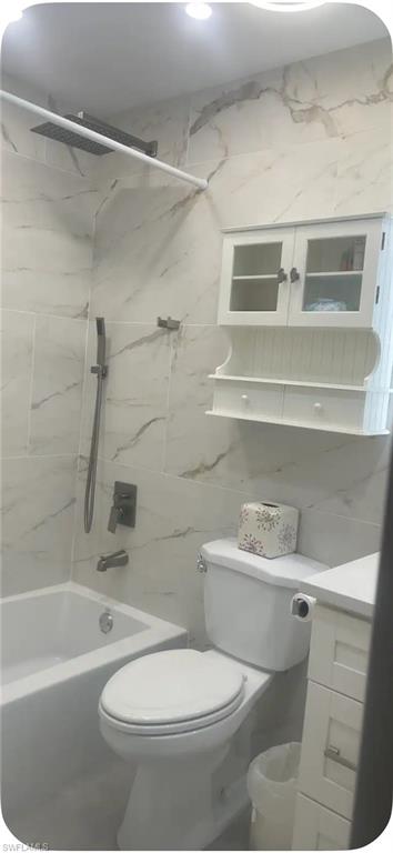 200 Turtle Lake Court, Unit 309 Naples, FL 34105 - Photo 8 of 17 a bathroom with a toilet and a shower