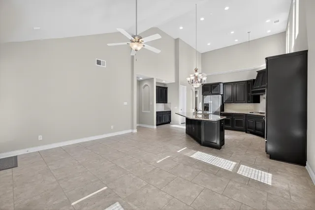 a kitchen with granite countertop a sink stove and cabinets
