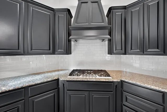 a kitchen with stainless steel appliances granite countertop a sink and stove top oven