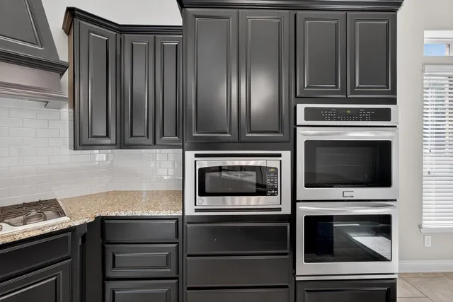 a kitchen with stainless steel appliances a refrigerator and a stove