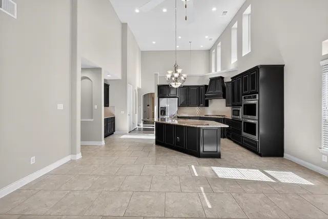 a large bathroom with a granite countertop double vanity sink and a mirror