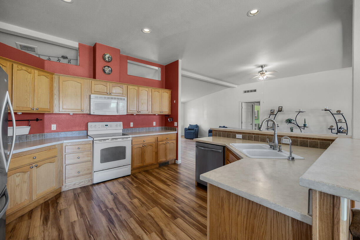 67500 Harrington Loop Road Bend, OR 97703 - Photo 13 of 72 a kitchen with stainless steel appliances sink stove top oven and cabinets