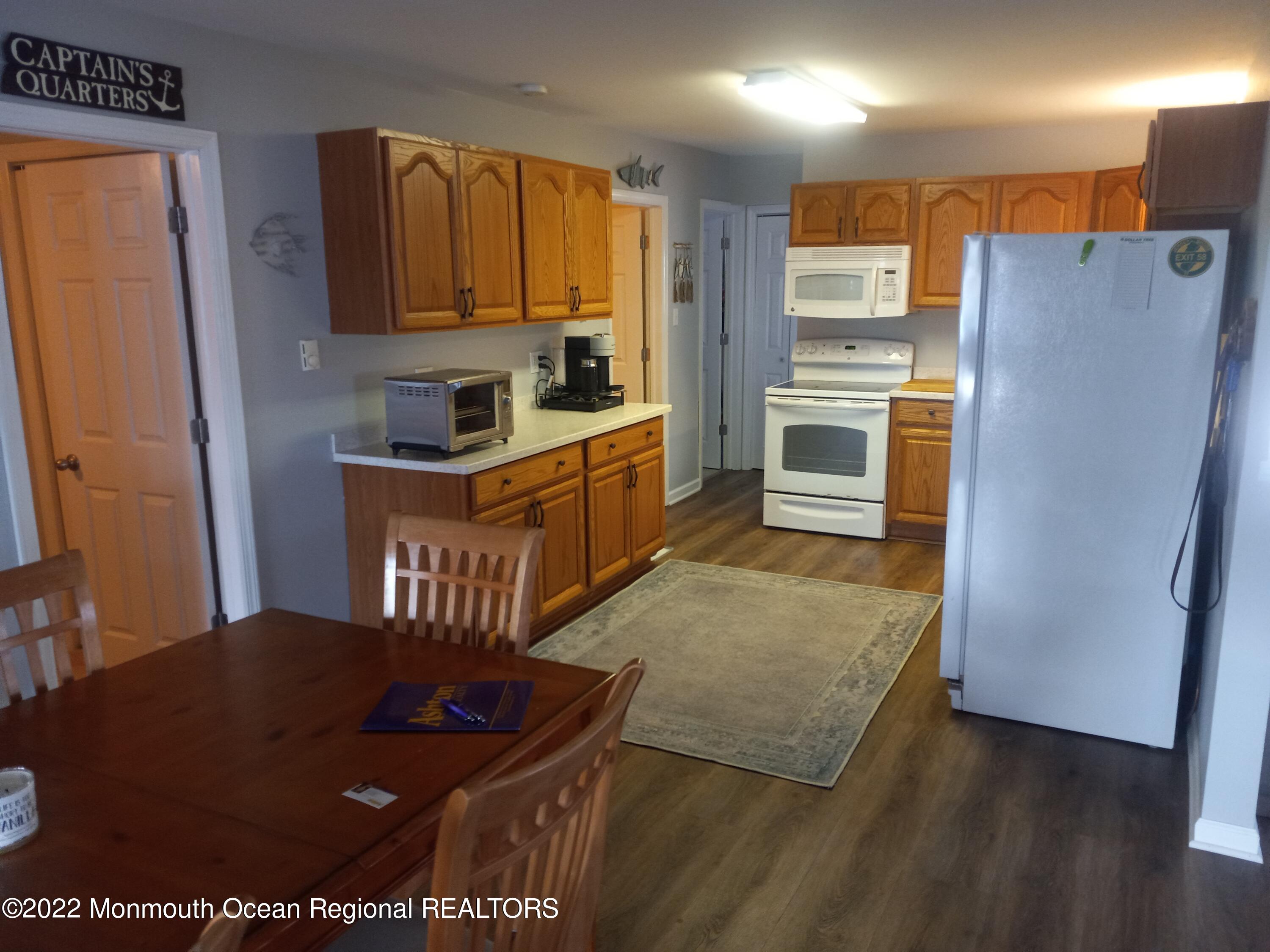 22 Ship Drive Little Egg Harbor, NJ 08087 - Photo 13 of 45 a kitchen with stainless steel appliances granite countertop a refrigerator a stove and a sink
