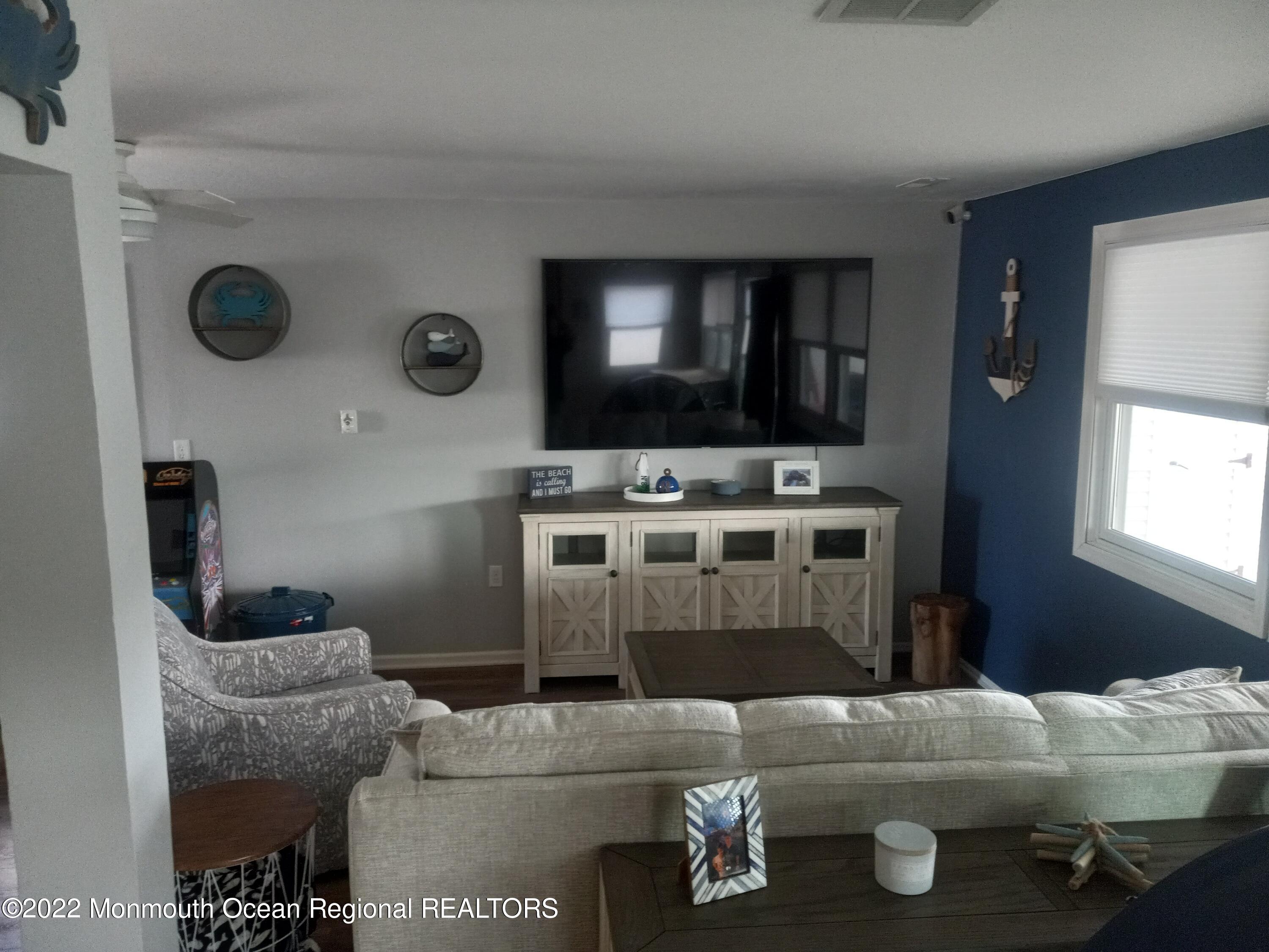 22 Ship Drive Little Egg Harbor, NJ 08087 - Photo 10 of 45 a living room with furniture and a flat screen tv