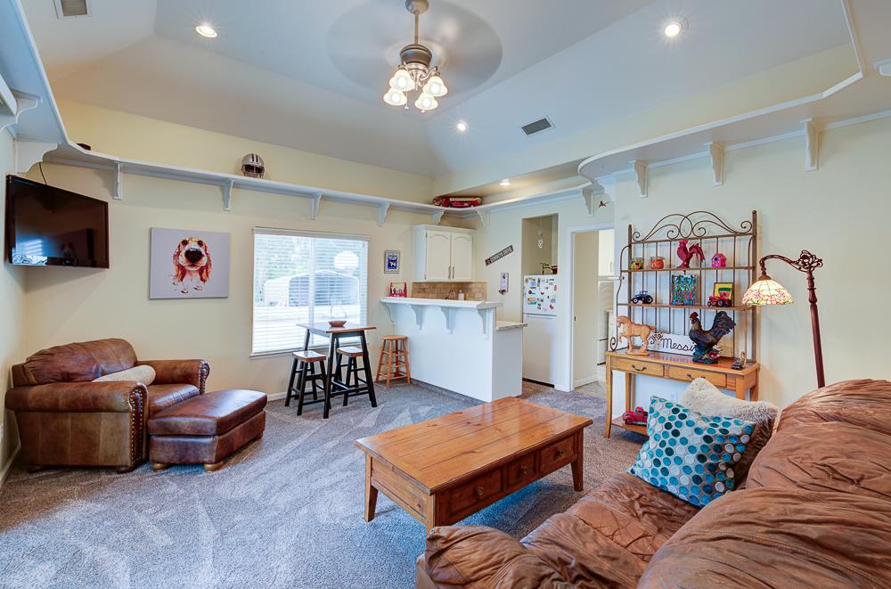 17465 Monreal Road Madera, CA 93636 - Photo 29 of 59 a living room with furniture and a flat screen tv