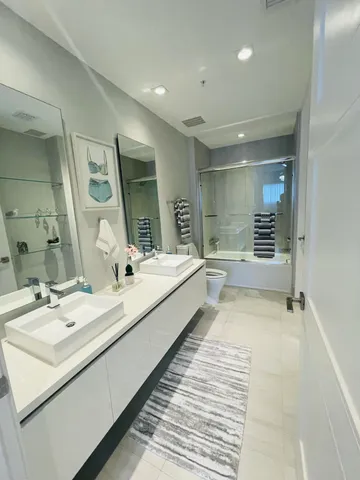 a bathroom with a double vanity sink and mirror