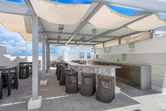 a kitchen with a sink a stove and cabinets