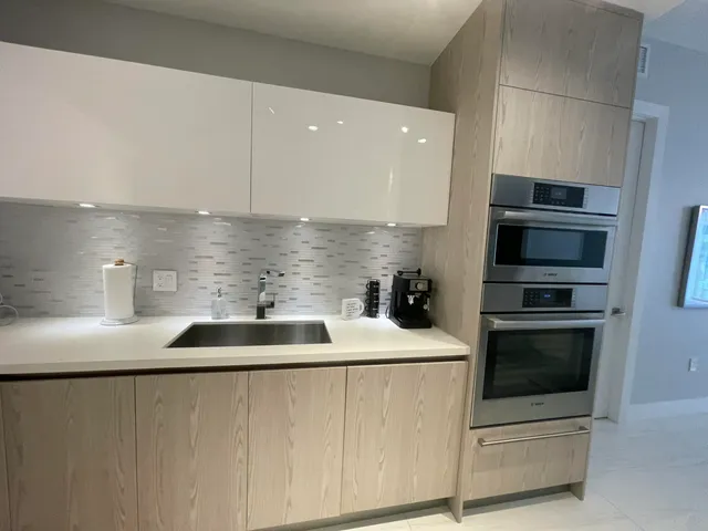 a kitchen with a sink and stainless steel appliances