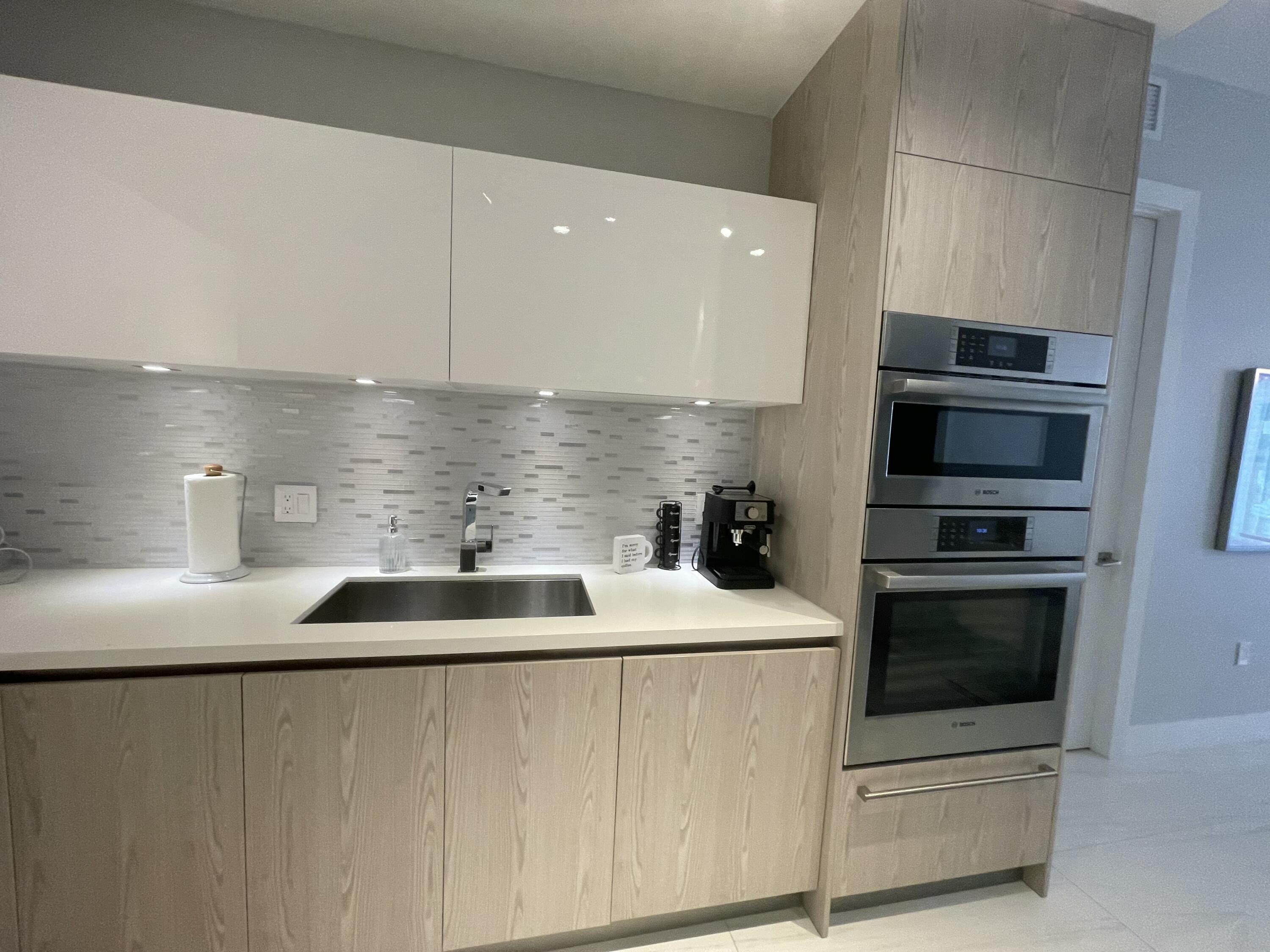 155 East Boca Raton Road, Unit 313 Boca Raton, FL 33432 - Photo 5 of 35 a kitchen with a sink and stainless steel appliances