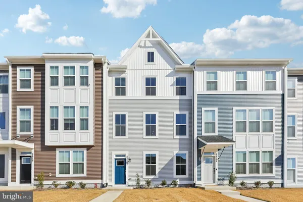 a front view of a residential apartment building with a yard