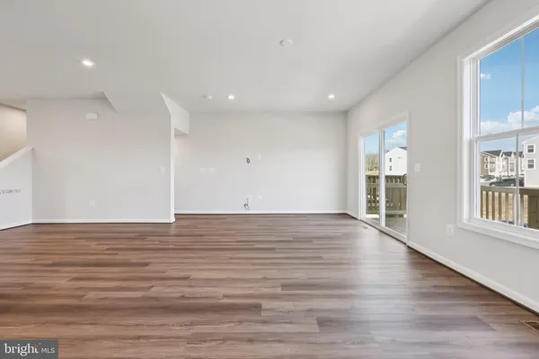 a view of a kitchen with a sink and dishwasher a refrigerator with wooden floor