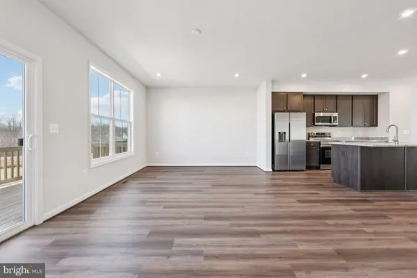a kitchen with stainless steel appliances a refrigerator and a stove top oven