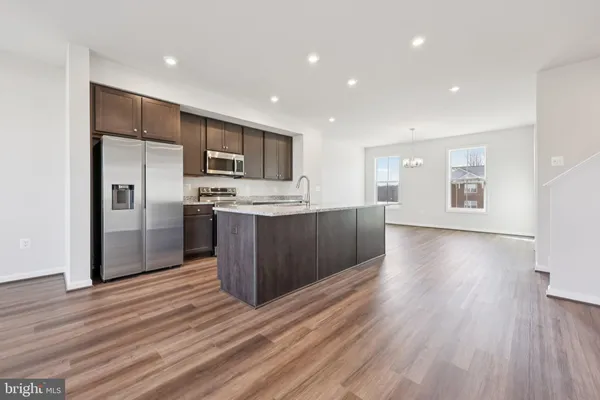 a kitchen with stainless steel appliances granite countertop a stove top oven and sink
