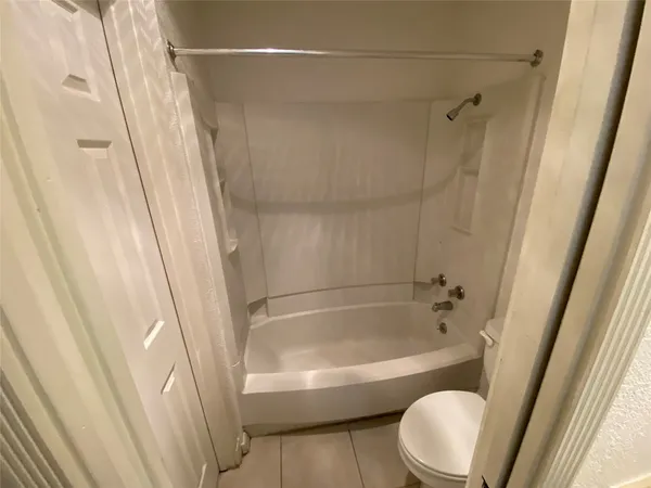 a bathroom with a bathtub and a toilet
