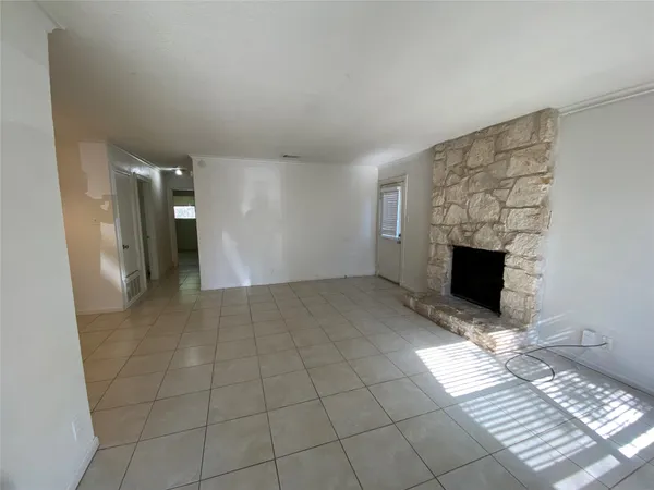 a view of a livingroom with wooden floor and a fireplace