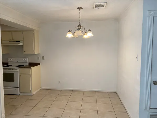 a kitchen with kitchen island white cabinets and stainless steel appliances