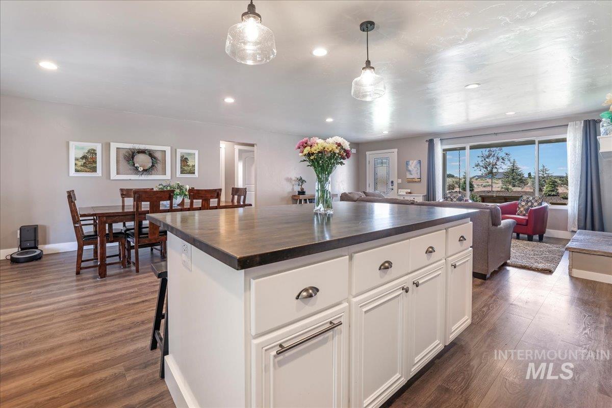 4076 North 3446 East Kimberly, ID 83341 - Photo 45 of 45 Kitchen featuring open floor plan, dark wood finished floors, recessed lighting, white cabinets, and a center island