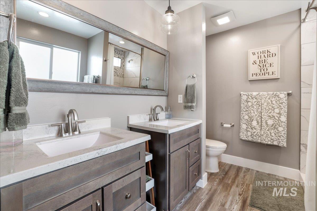 4076 North 3446 East Kimberly, ID 83341 - Photo 18 of 45 Bathroom with wood finished floors, two vanities, and a shower