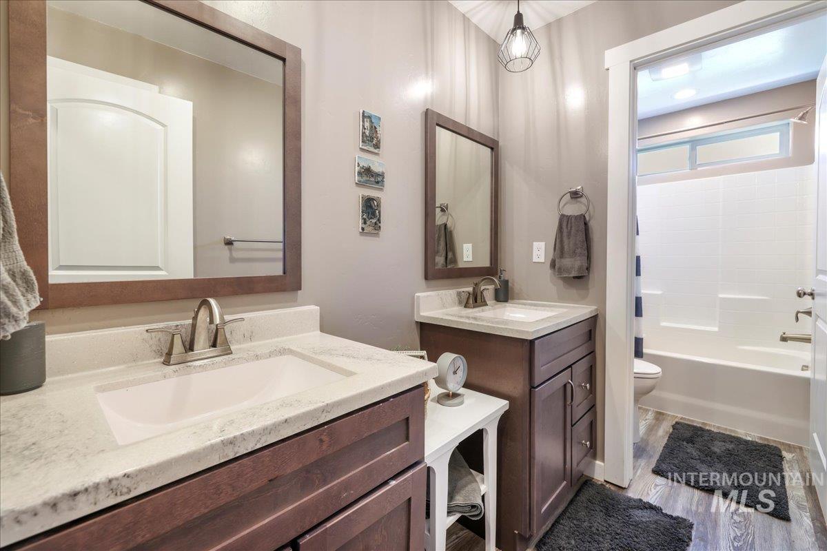 4076 North 3446 East Kimberly, ID 83341 - Photo 22 of 45 Bathroom with two vanities, shower / tub combination, and wood finished floors