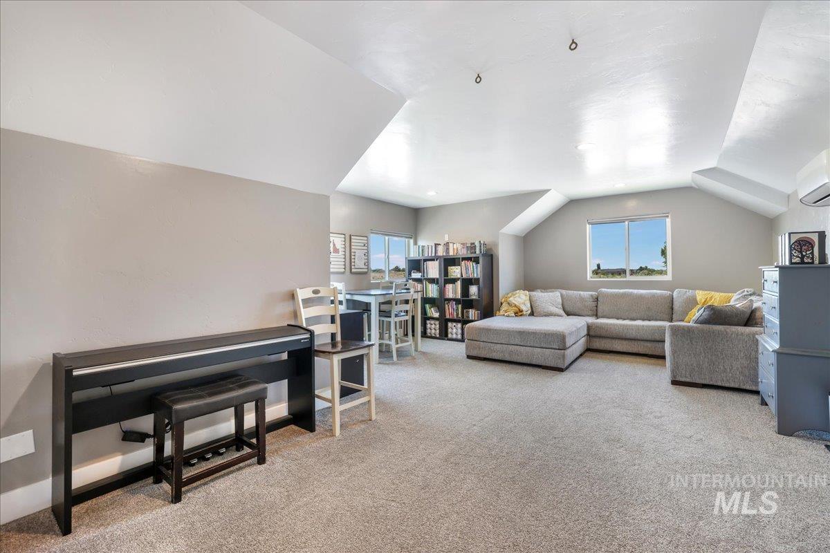 4076 North 3446 East Kimberly, ID 83341 - Photo 27 of 45 Carpeted living room featuring plenty of natural light and lofted ceiling
