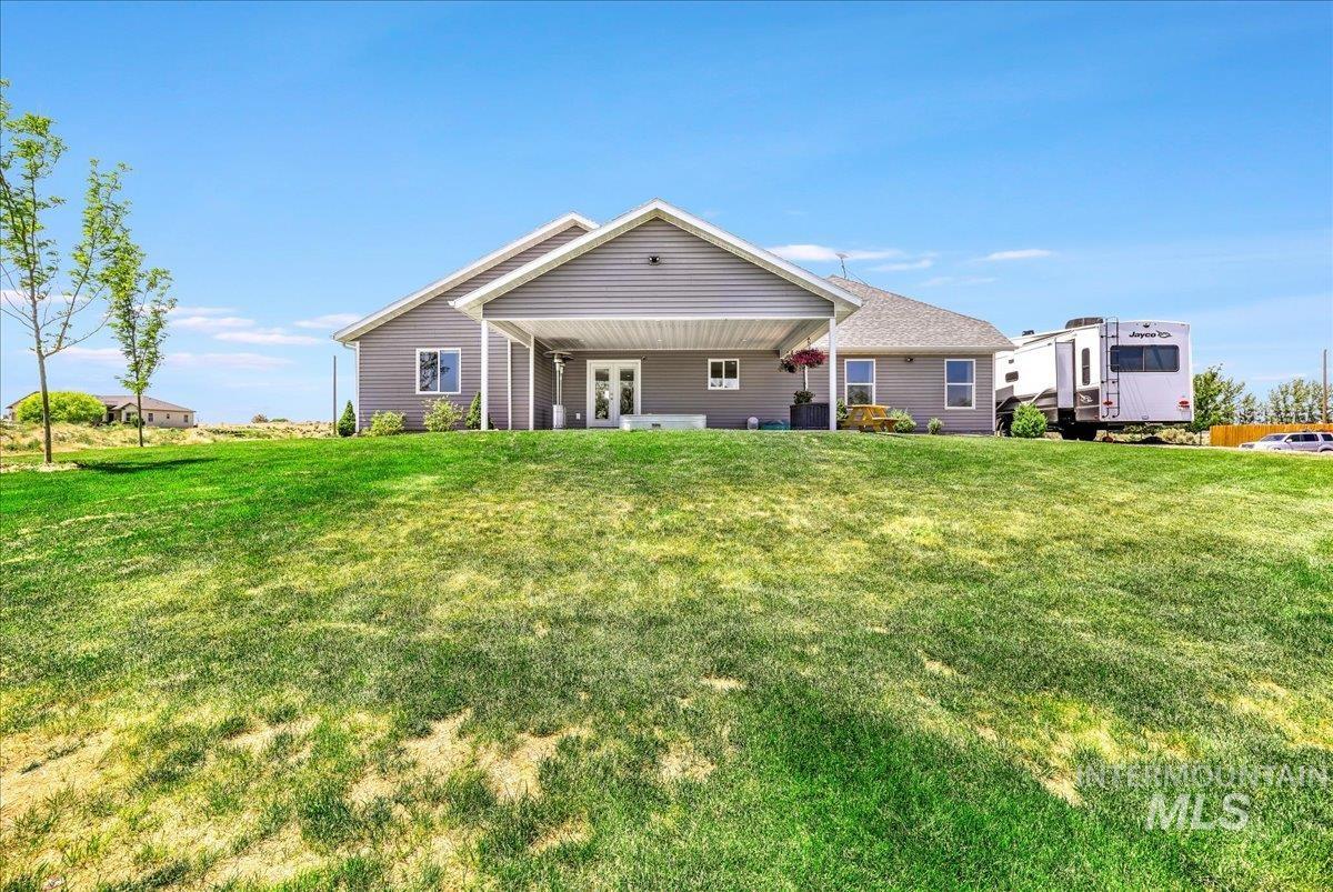 4076 North 3446 East Kimberly, ID 83341 - Photo 35 of 45 Back of house with french doors and a lawn