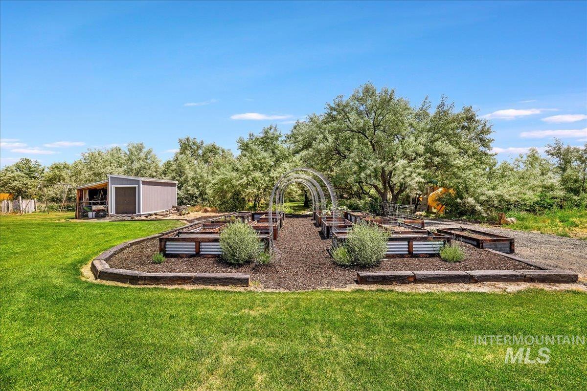 4076 North 3446 East Kimberly, ID 83341 - Photo 37 of 45 View of grassy yard with a vegetable garden and an outdoor structure