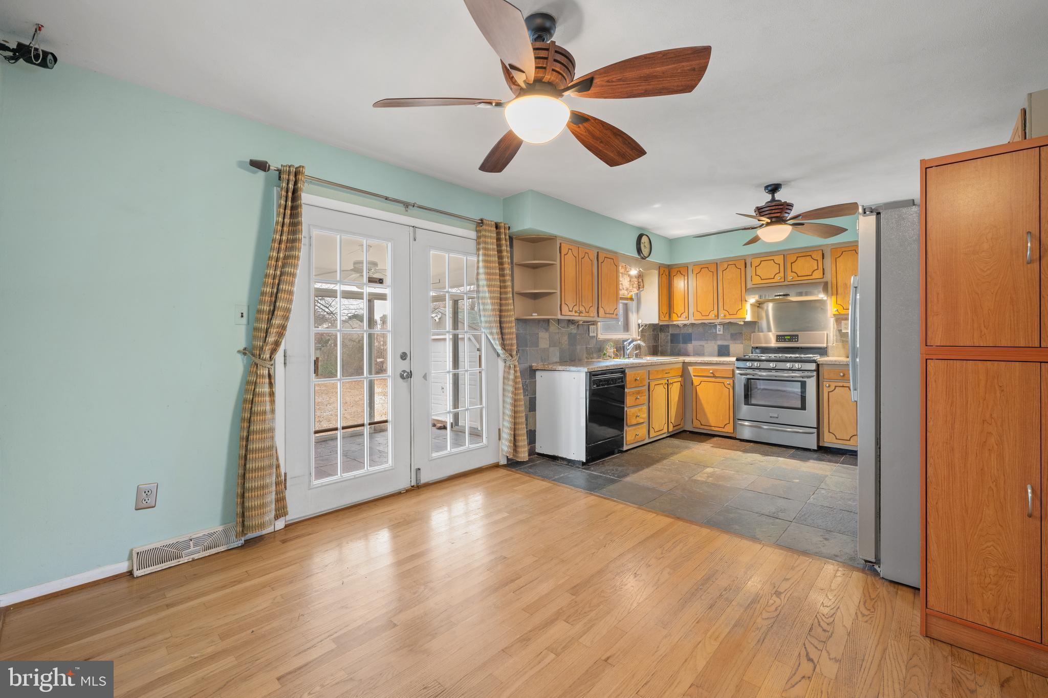866 North Brewster Road Vineland, NJ 08361 - Photo 15 of 46 a view of a kitchen with wooden floor electronic appliances and a ceiling fan