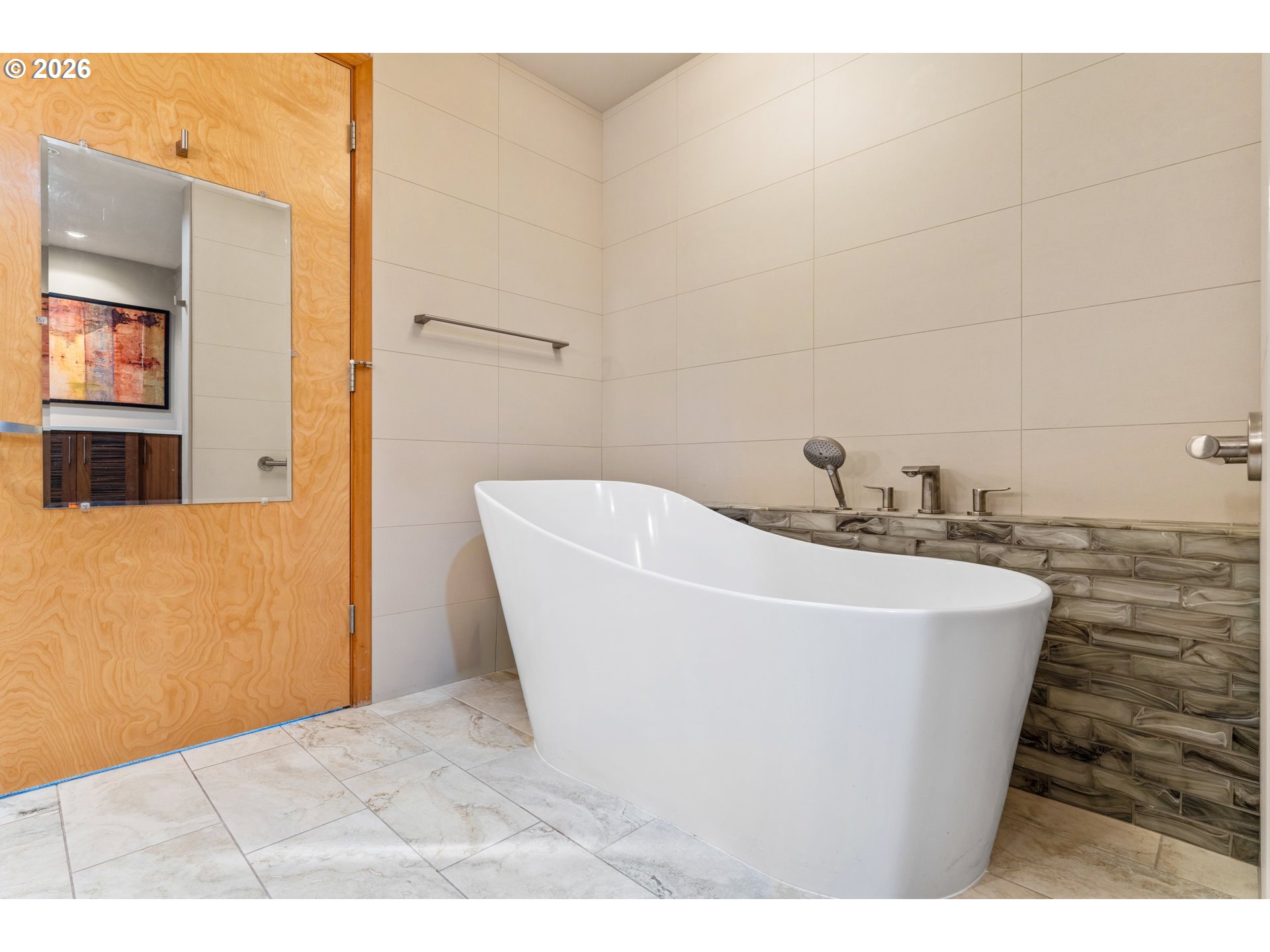 1030 Northwest Johnson Street, Unit 611 Portland, OR 97209 - Photo 23 of 34 a white bath tub sitting in a bathroom