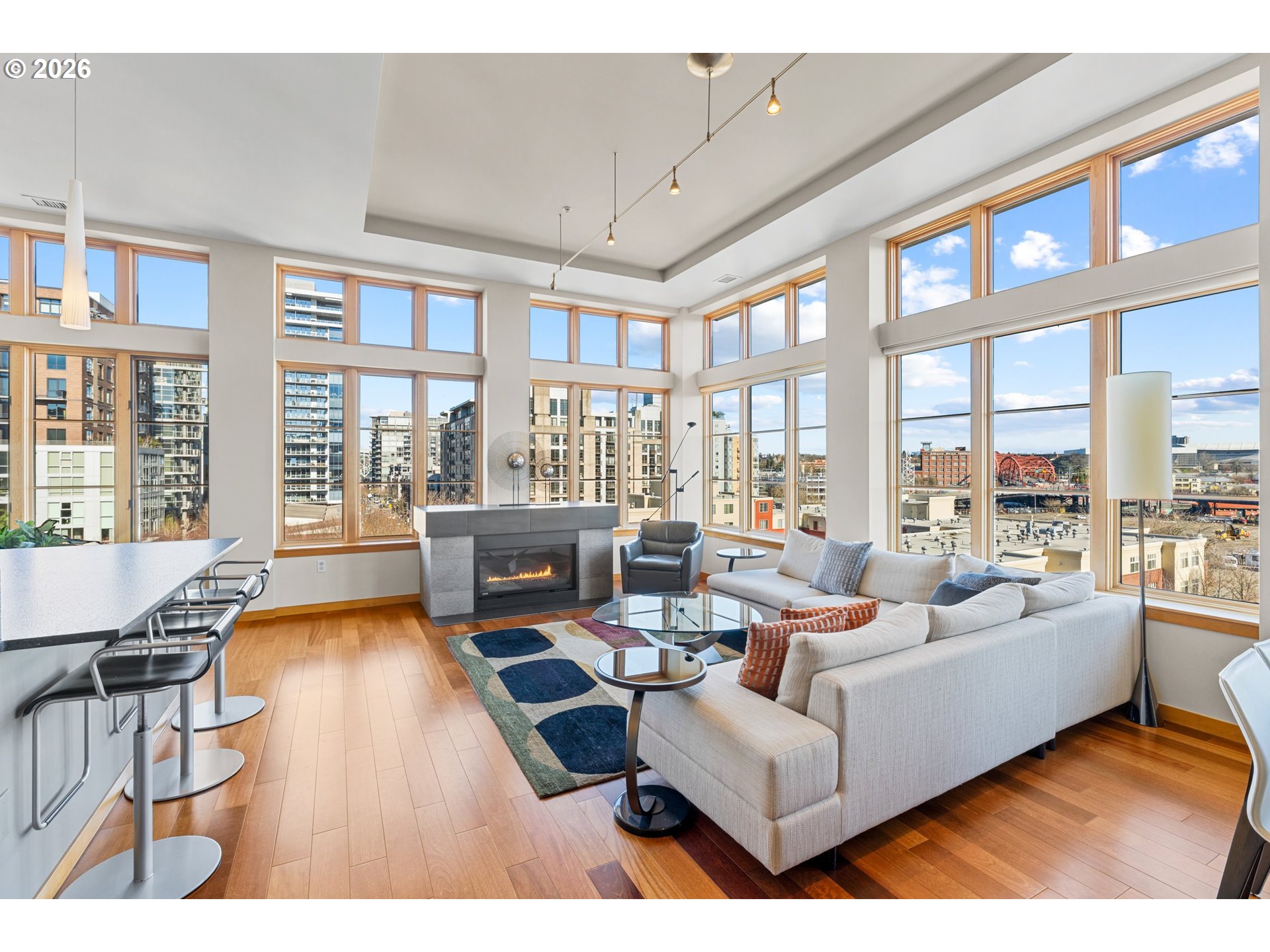 1030 Northwest Johnson Street, Unit 611 Portland, OR 97209 - Photo 5 of 34 a living room with furniture and floor to ceiling windows