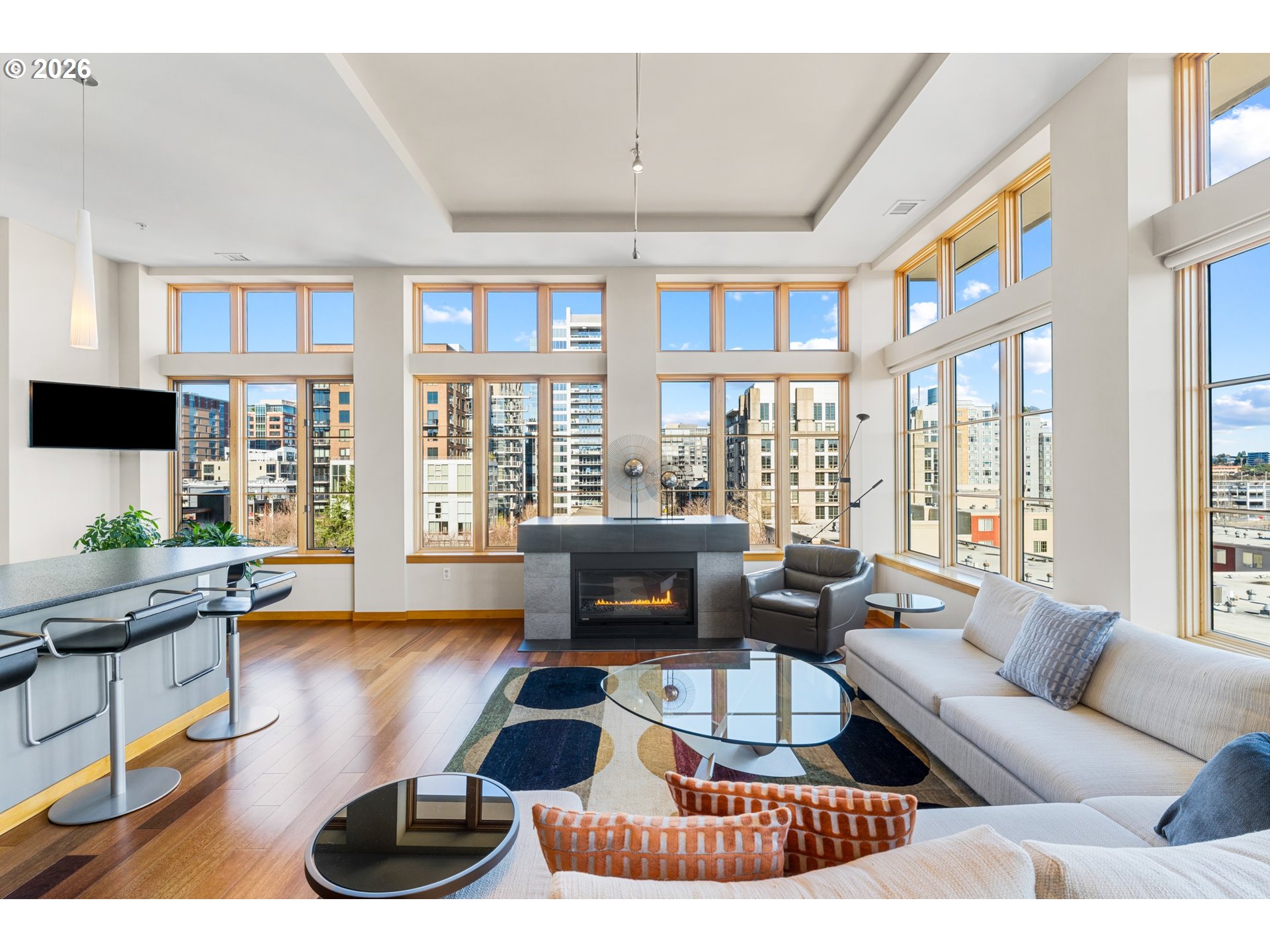 1030 Northwest Johnson Street, Unit 611 Portland, OR 97209 - Photo 6 of 34 a living room with furniture fireplace and a large window
